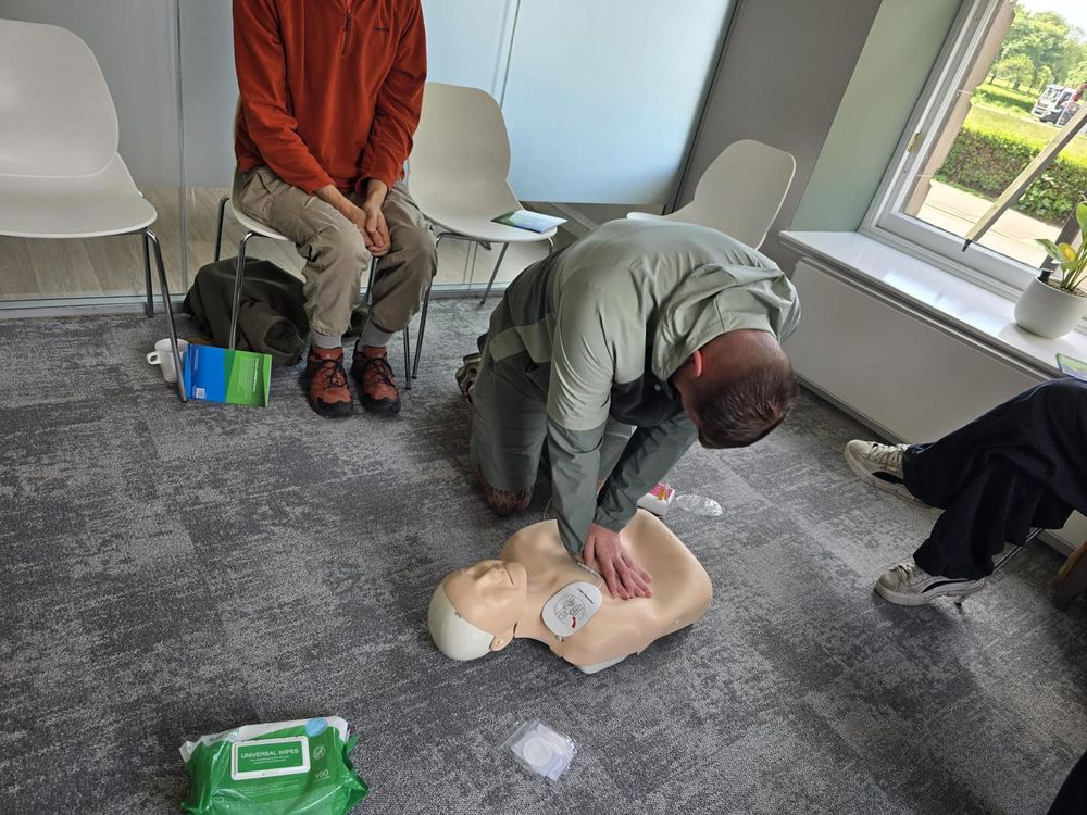 Trainee performing CPR with an AED defibrillator during workplace first aid training