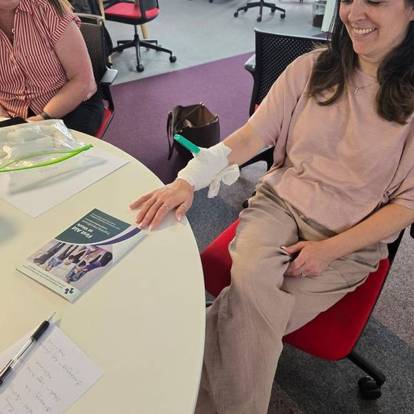 Practising bandaging and wound dressing during a first aid course