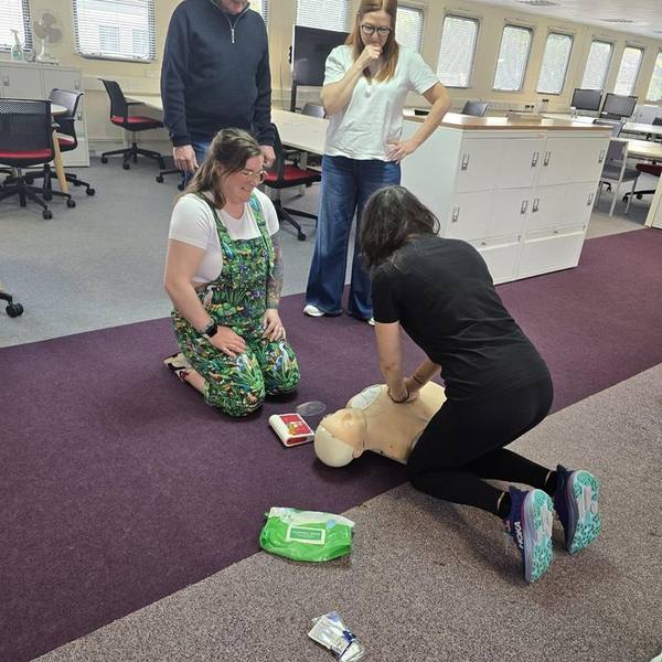 Workplace first aid training using an AED defibrillator